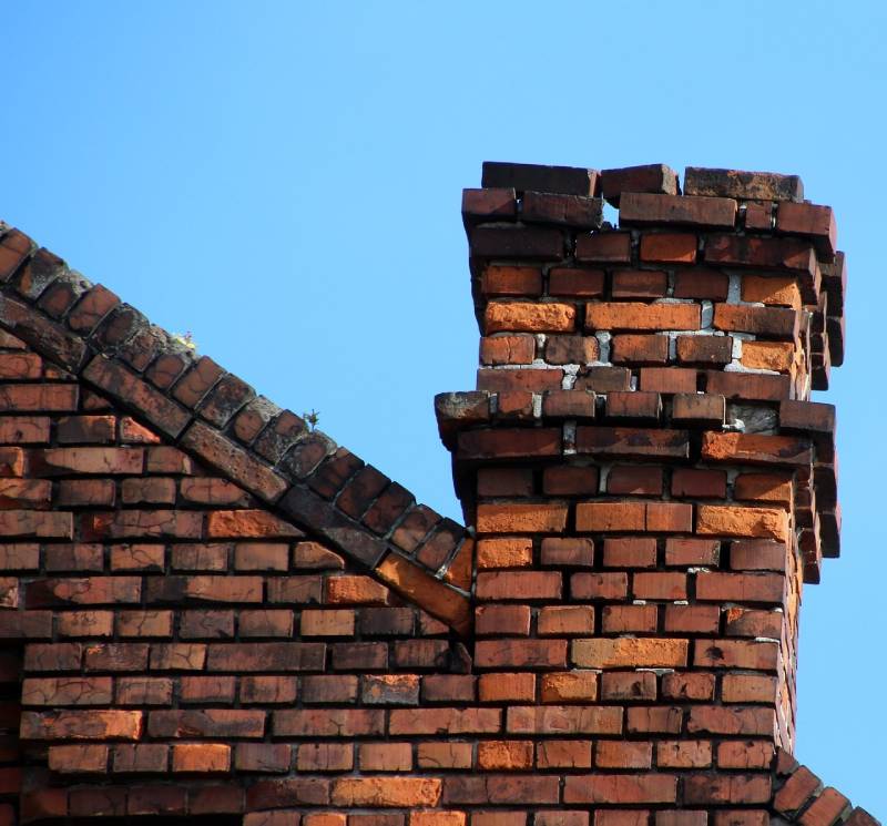 Damaged chimney on an Van Alstyne home showing cracks and missing mortar